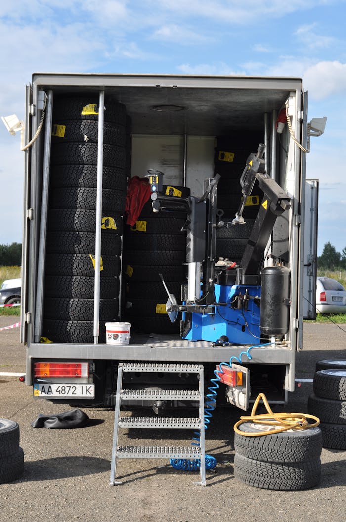 gallery-01 A mobile tire repair truck stocked with tires and machinery for roadside assistance.